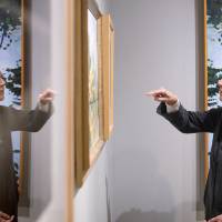 Jim and Marie Preston looking at piece of artwork